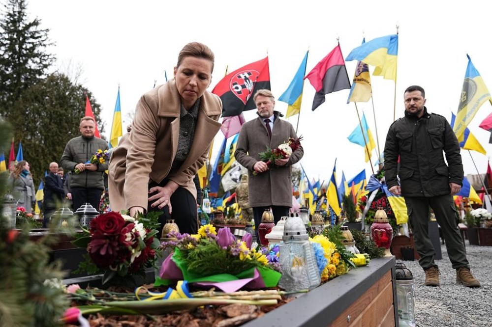 Ukrainian President Volodymyr Zelenskyy, Denmark's Prime Minister Mette Frederiksen, and her husband Bo Tengberg, center, lay wreaths during a memorial ceremony at the Field of Mars at Lychakiv Cemetery in Lviv, Ukraine, Friday Feb. 23, 2024. (Mads Claus Rasmussen/Ritzau Scanpix via AP)