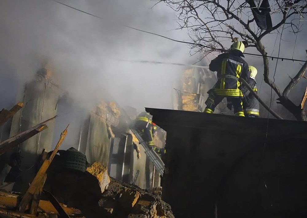 In this photo provided by the Ukrainian Emergency Service, firefighters work on the site of a burning building after a Russian attack in Odesa, Ukraine, Friday, Feb. 23, 2024. (Ukrainian Emergency Service via AP)