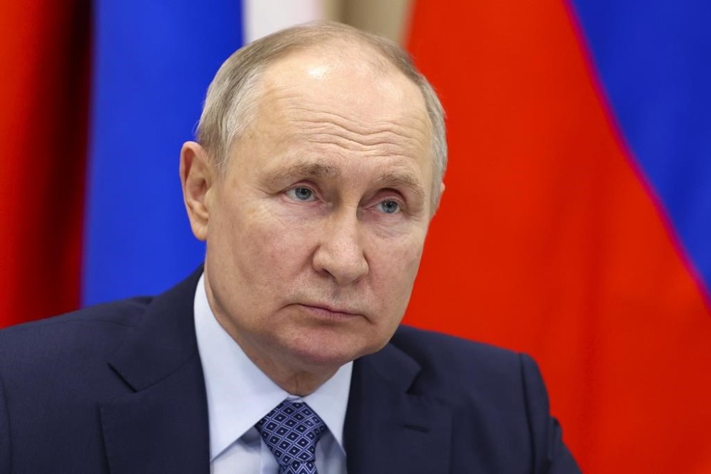 FILE - Russian President Vladimir Putin attends a meeting with officials in the town of Tsivilsk, Republic of Chuvash, Russia, Feb. 22, 2024. The U.S. government is hitting Russia with the largest tranche of financial penalties imposed on Moscow since its 2022 invasion of Ukraine. They target roughly 600 people and firms from Russia to China to the United Arab Emirates. (Alexander Kazakov, Sputnik, Kremlin Pool Photo via AP, File)