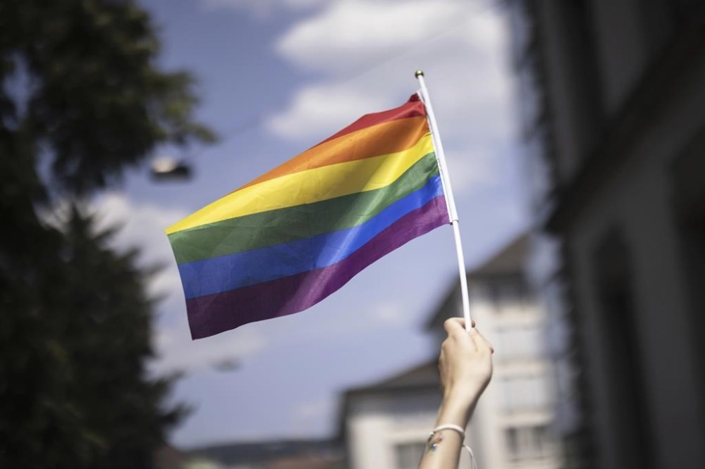 A town north of Edmonton has voted in favour of a bylaw that bans Pride flags and rainbow crosswalks from being displayed on municipal property. A person holds a Pride flag during the Zurich Pride parade in Zurich, Switzerland, Saturday, June 17, 2023. THE CANADIAN PRESS/AP-Michael Buholzer/Keystone via AP