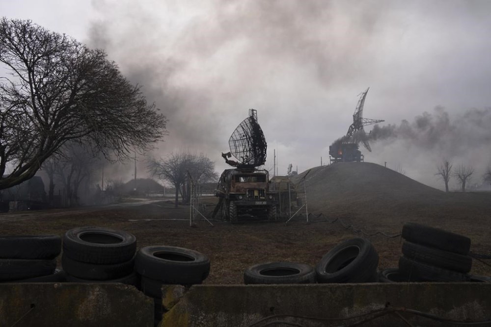 FILE - Smoke rise from an air defense base in the aftermath of an apparent Russian strike in Mariupol, Ukraine, on Feb. 24, 2022. Ukraine is marking Saturday, Feb. 24, 2024, two years since Russia’s full-scale invasion, with a string of foreign dignitaries and officials expected to visit the capital, Kyiv, in solidarity as Ukrainian forces run low on ammunition and weaponry and Western aid hangs in the balance. (AP Photo/Evgeniy Maloletka, File)