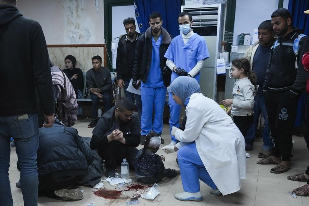 Palestinians wounded in the Israeli bombardment of the Gaza Strip are brought to Al Aqsa hospital in Deir al Balah, Friday, Feb. 23, 2024. (AP Photo/Adel Hana)