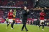 Manchester United's head coach Erik ten Hag applauds to supporters after the English Premier League soccer match between Manchester United and Fulham at Old Trafford stadium in Manchester, Saturday, Feb. 24, 2024.(AP Photo/Dave Thompson)