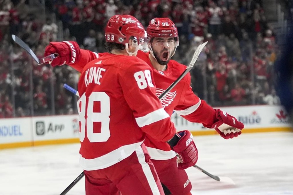 Detroit Red Wings right wing Patrick Kane (88) celebrates his goal with Jake Walman (96) against the St. Louis Blues in the first period of an NHL hockey game Saturday, Feb. 24, 2024, in Detroit. (AP Photo/Paul Sancya)