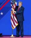 Republican presidential candidate former President Donald Trump kisses the American flag as he arrives to speak during the Conservative Political Action Conference, CPAC 2024, at the National Harbor, in Oxon Hill, Md., Saturday, Feb. 24, 2024. (AP Photo/Jose Luis Magana)