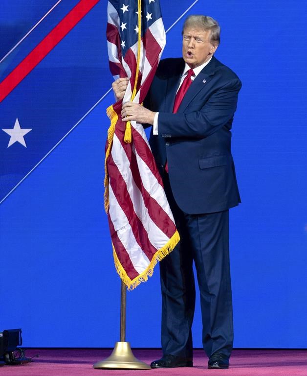 Republican presidential candidate former President Donald Trump kisses the American flag as he arrives to speak during the Conservative Political Action Conference, CPAC 2024, at the National Harbor, in Oxon Hill, Md., Saturday, Feb. 24, 2024. (AP Photo/Jose Luis Magana)