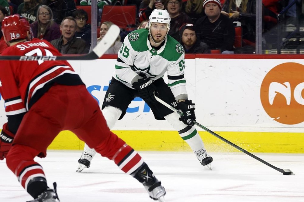 Dallas Stars' Matt Duchene (95) looks to shoot the puck past Carolina Hurricanes' Jaccob Slavin (74) during the first period of an NHL hockey game in Raleigh, N.C., Saturday, Feb. 24, 2024. (AP Photo/Karl B DeBlaker)