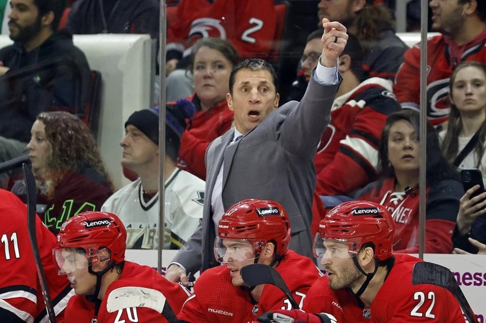 Carolina Hurricanes head coach Rod Brind'Amour, center top, signals goaltender Pyotr Kochetkov (52) to abandon the net during the third period of an NHL hockey game against the Dallas Stars in Raleigh, N.C., Saturday, Feb. 24, 2024. (AP Photo/Karl B DeBlaker)
