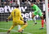 Wolfsburg's Maxence Lacroix scores past Frankfurt goalkeeper Kevin Trapp during the Bundesliga soccer match between Eintracht Frankfurt and VfL Wolfsburg at Deutsche Bank Park in Frankfurt, Germany, Sunday Feb. 25, 2024. (Arne Dedert/dpa via AP)