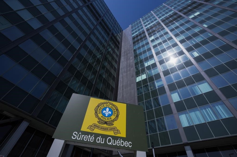 A day after Quebec provincial police arrested nine people in connection with what they've described as a turf war among organized criminals in eastern Quebec, Quebec City police say four more people have been arrested in connection with a series of police operations targeting the violent conflict. Surete du Quebec headquarters is seen in Montreal, Monday, May 29, 2023. THE CANADIAN PRESS/Christinne Muschi