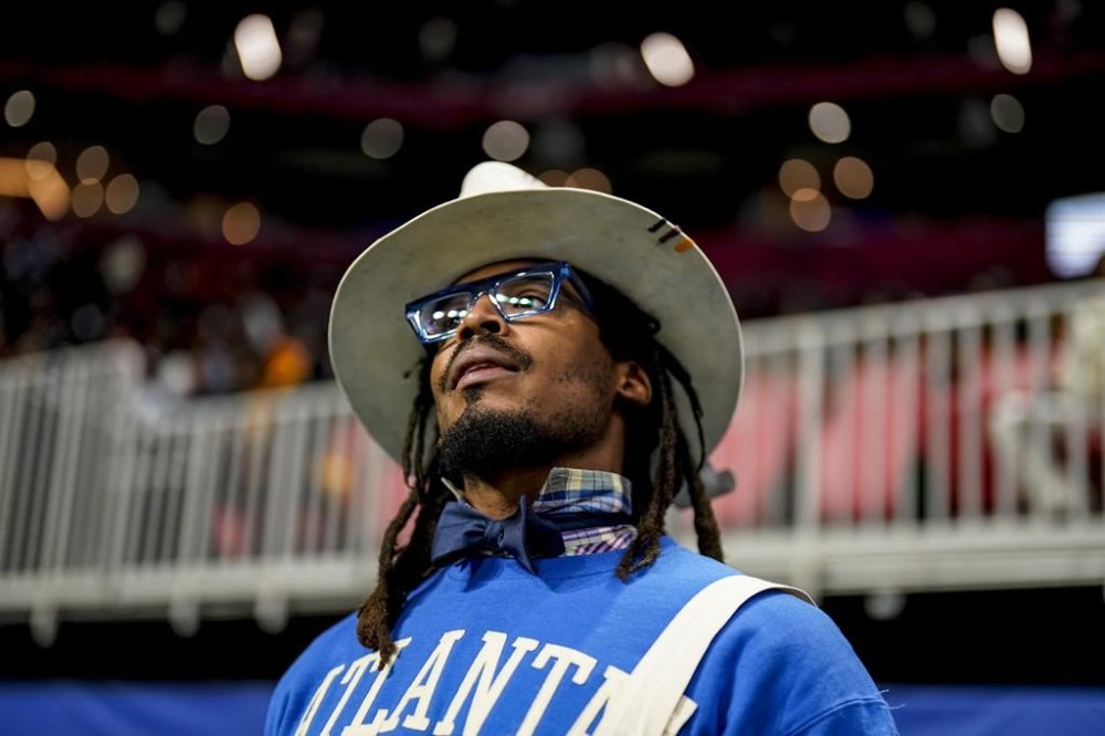 FILE - NFL football player Cam Newton watches play between Howard and Florida A&M during the first half of an NCAA Celebration Bowl football game, Dec. 16, 2023, in Atlanta. A video surfaced Sunday, Feb. 25, 2024, that appeared to show Newton being involved in a scuffle at a 7-on-7 youth football tournament in Atlanta. (AP Photo/Mike Stewart, File)