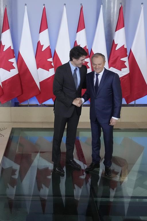 Poland's Prime Minister Donald Tusk, right, greets Canada's Prime Minister Justin Trudeau ahead of talks on European security and support for Poland's neighbor, Ukraine, in its struggle against Russia's aggression, in Warsaw, Poland, on Monday, Feb. 26, 2024. Trudeau is in Poland after a visit to Kyiv. (AP Photo/Czarek Sokolowski)