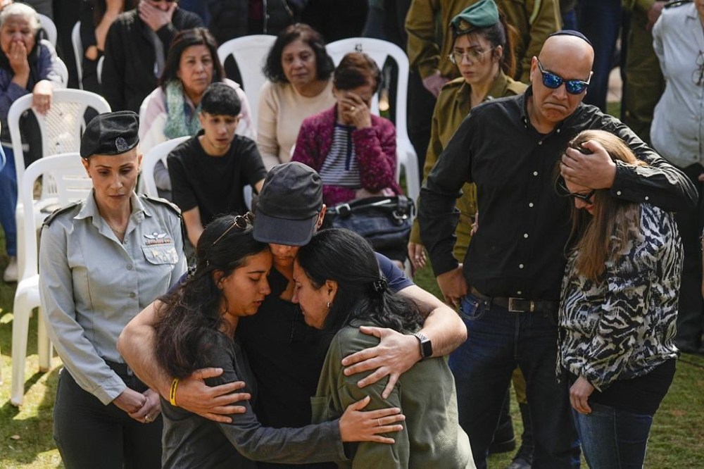 Family of Sergeant Oz Daniel mourn in grief during his funeral in Kfar Saba, Israel, Monday, Feb. 26, 2024. Daniel, 19, believed to have been among those killed in the initial Oct. 7 Hamas attack, was declared dead by the military, with his remains still in Gaza. (AP Photo/Ohad Zwigenberg)