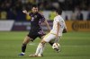Inter Miami forward Lionel Messi (10) dribbles the ball away from Los Angeles Galaxy defender Julián Aude (3) during the second half of an MLS soccer match, Sunday, Feb. 25, 2024, in Carson, Calif. (AP Photo/Kyusung Gong)