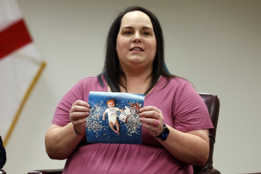 Elizabeth Goldman holds a photo of her daughter, Zari Grace, as she tells her story to Secretary of U.S. Health and Human Services, Xavier Becerra who hosted a panel discussion with families directly affected by the Alabama Supreme Court Court decision, Tuesday, Feb. 27, 2024, in Birmingham, Ala. (AP Photo/Butch Dill)