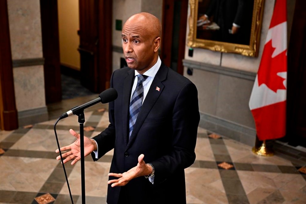 Minister of International Development Ahmed Hussen speaks in the foyer of the House of Commons before Question Period on Parliament Hill in Ottawa, Thursday, Feb. 15, 2024. Hussen's office says Canada is working to airdrop humanitarian aid to the Gaza Strip as soon as possible. THE CANADIAN PRESS/Justin Tang