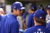 Los Angeles Dodgers designated hitter Shohei Ohtani, left, and starting pitcher Yoshinobu Yamamoto (18) talk in the dugout during a spring training baseball game against the Texas Rangers, Wednesday, Feb. 28, 2024, in Surprise, Ariz. (AP Photo/Lindsey Wasson)