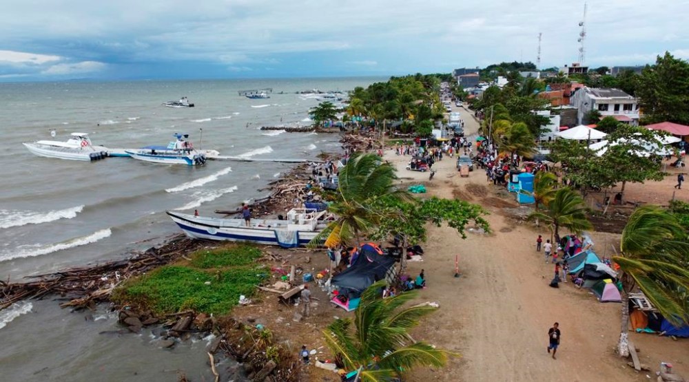 FILE - Migrants gather in Necocli, Colombia, a stopping point for migrants taking boats to Acandi which leads to the Darien Gap, Oct. 13, 2022. The flow of thousands of migrants daily through the migratory highway, the Darien Gap, has been cut off following the Feb. 26, 2024 capture in Necoclí of some boat captains who had been ferrying the migrants to the starting point of their jungle trek. (AP Photo/Fernando Vergara, File)