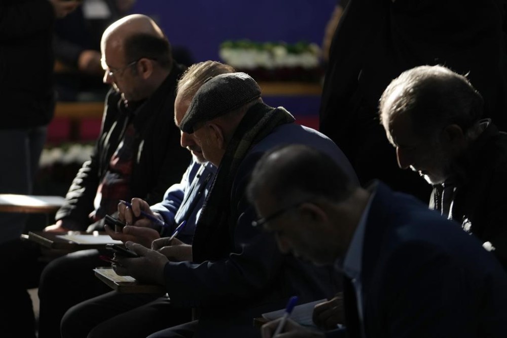 Voters fill out their ballots in the parliamentary and Assembly of Experts elections at a polling station in Tehran, Iran, Friday, March 1, 2024. Iran began voting Friday in its first elections since the mass 2022 protests over its mandatory hijab laws after the death of Mahsa Amini, with questions looming over just how many people will turn out for the poll. (AP Photo/Vahid Salemi)