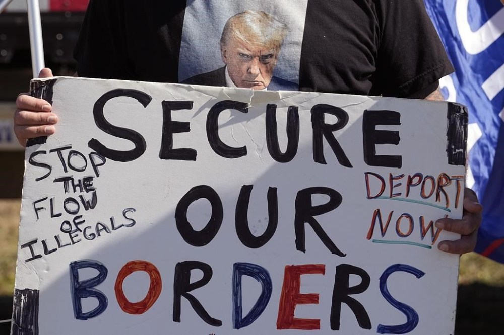 FILE - Phill Cady holds a sign during a