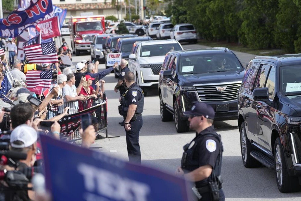 Supporters cheer as the motorcade carrying former President Donald Trump arrives at the Federal Courthouse, Friday, March 1, 2024, in Fort Pierce, Fla. (AP Photo/Wilfredo Lee)