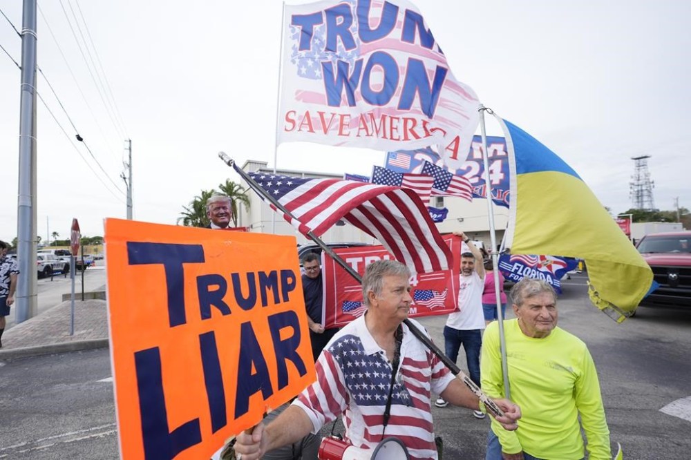Philip Stasik, center, holds up a