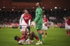 PSG's goalkeeper Gianluigi Donnarumma laughs as he stands over Monaco's Wilfried Singo during the French League One soccer match between Monaco and Paris Saint-Germain at the Stade Louis II in Monaco, Friday, March 1, 2024. (AP Photo/Daniel Cole)