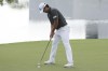 S.H. Kim of South Korea drops his putt on the 17th hole during the first round of the Cognizant Classic golf tournament, Thursday, Feb. 29, 2024, in Palm Beach Gardens, Fla. (AP Photo/Marta Lavandier)