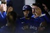 Toronto Blue Jays' Santiago Espinal celebrates after scoring in the third inning of a spring training baseball game against the New York Yankees Friday, March 1, 2024, in Tampa, Fla. (AP Photo/Charlie Neibergall)