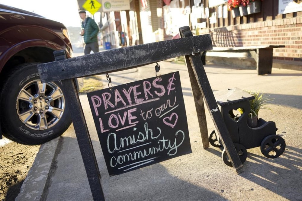FILE - A sign on the sidewalk outside an antique store in Spartansburg, Pa., on Thursday, Feb. 29, 2024. Shawn C. Cranston was arrested Saturday, March 2, and charged with the slaying of a pregnant Amish woman whose body was found last week. (AP Photo/Gene J. Puskar)