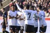 Eintracht Frankfurt's players celebrate after Heidenheim's goalkeeper Mueller scored an own goal during the Bundesliga soccer match between 1. FC Heidenheim and Eintracht Frankfurt in Heidenheim, Germany, Saturday, March 2, 2024. (Tom Weller/dpa via AP)