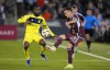 Colorado Rapids midfielder Cole Bassett, right, kicks the ball as Nashville SC defender Shaq Moore, left, covers during the first half of an MLS soccer match Saturday, March 2, 2024, in Commerce City, Colo. (AP Photo/David Zalubowski)
