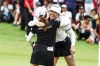 Hannah Green of Australia, right, and Ayaka Furoe of Japan embraces after completing the 18th hole of the final round of the HSBC Women's Wold Championship at the Sentosa Golf Club in Singapore Sunday, March 3, 2024. (AP Photo/Danial Hakim)
