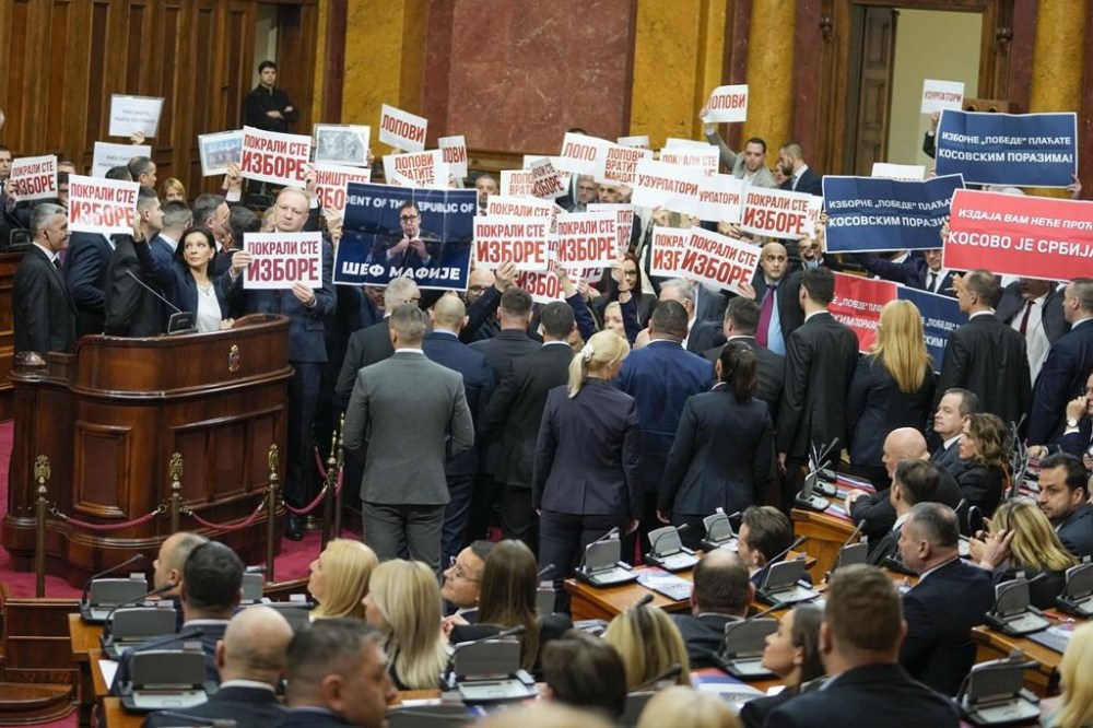 FILE - Opposition lawmakers hold banners reading: 