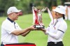 Hannah Green, right, of Australia receives her trophy after winning the HSBC Women's Wold Championship at the Sentosa Golf Club in Singapore Sunday, March 3, 2024. (AP Photo/Danial Hakim)