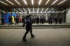 A protester walks as police line the entrance to the Art Gallery of Ontario, where a cancelled event for Canada's Prime Minister Justin Trudeau and Italy's Prime Minister Giorgia Meloni, was to take place, in Toronto, Saturday, Mar. 2, 2024. THE CANADIAN PRESS/Cole Burston
