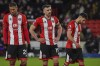 Sheffield United's Vinicius Souza, left, Jack Robinson, center, and George Baldock react during the English Premier League soccer match between Sheffield United and Arsenal at the Bramall Lane stadium in Sheffield, England, Monday, March 4, 2024. (AP Photo/Rui Vieira)