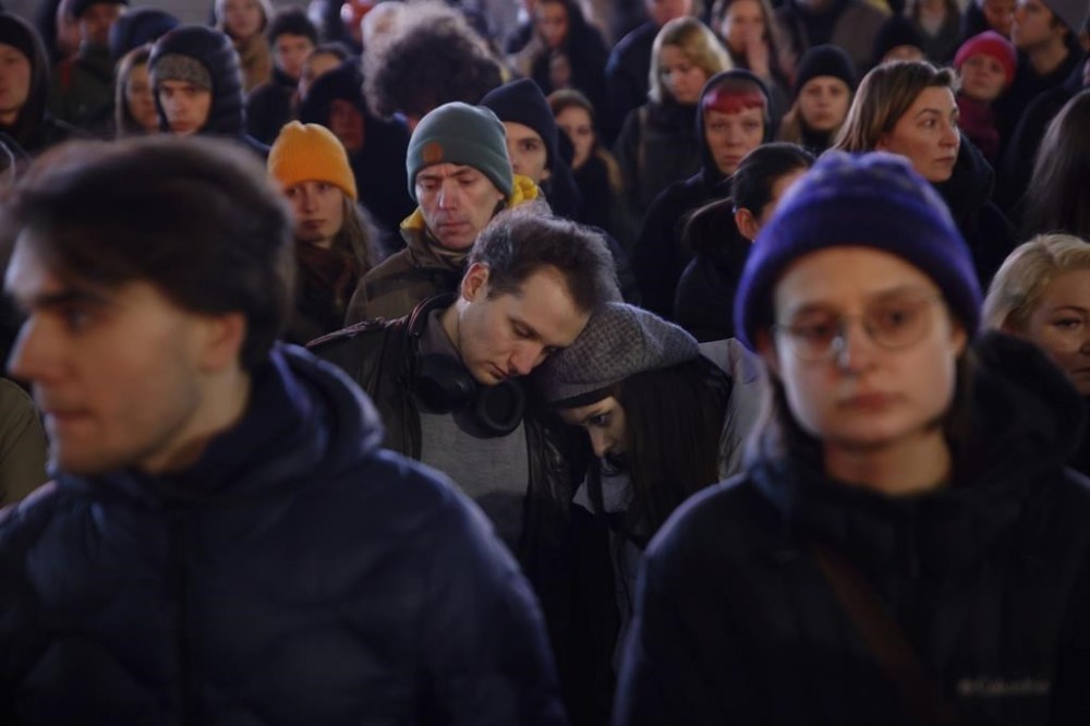 A couple hugs each other during a march in silence to commemorate Lizaveta, a 25-year-old Belarusian woman who died after a being brutally attacked and raped on the streets of Warsaw last month, in Warsaw Poland, Wednesday, March 6, 2024. The crime has shocked people across Poland. Poles, Belarusians and Ukrainians gathered at the site of the crime in downtown Warsaw, placing flowers and lighting candles in honor of the woman known only as Lizaveta, or Liza. (AP Photo/Michal Dyjuk)