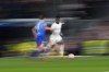 Real Madrid's Vinicius Junior, right, challenges for the ball with Leipzig's Willi Orban during the Champions League round of 16 second leg soccer match between Real Madrid and RB Leipzig at the Santiago Bernabeu stadium in Madrid, Spain, Wednesday, March 6, 2024. (AP Photo/Manu Fernandez)