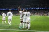 Real Madrid's Vinicius Junior, centre, celebrates with his teammates after scoring his side's opening goal during the Champions League round of 16 second leg soccer match between Real Madrid and RB Leipzig at the Santiago Bernabeu stadium in Madrid, Spain, Wednesday, March 6, 2024. (AP Photo/Manu Fernandez)