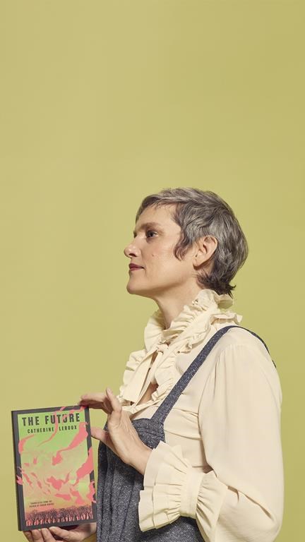 Montreal-based writer Heather O'Neill holds a copy of Catherine Leroux's post-apocalyptic novel