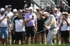 Sam Burns, front right, hits out of a bunker onto the 14th green during the first round of the Arnold Palmer Invitational golf tournament, Thursday, March 7, 2024, in Orlando, Fla. (AP Photo/Phelan M. Ebenhack)