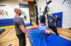 MIKAELA MACKENZIE / WINNIPEG FREE PRESS
                                Graham Forsyth tries out the trapeze with help from Dan Sarahs (left) and Chris Stradbrow during a circus arts professional development session at Heritage School on Friday, Feb. 2, 2024. For Maggie story. Winnipeg Free Press 2024.