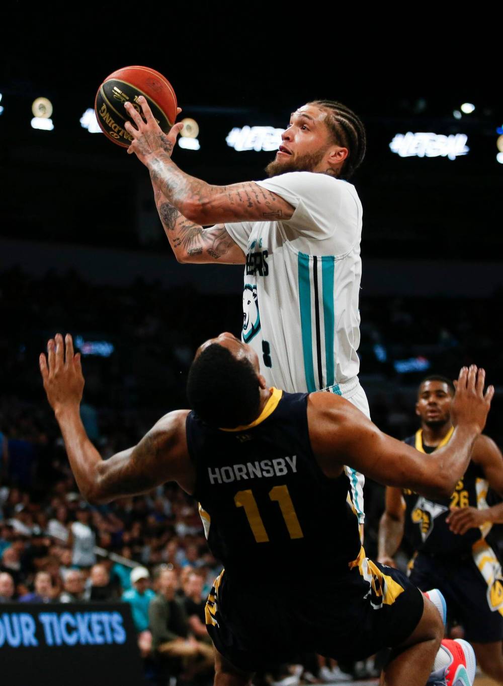 Winnipeg Sea Bears’ Teddy Allen (8) goes for the basket against Edmonton Stingers’ Nick Hornsby (11) in a game last June. (John Woods / Winnipeg Free Press files)
