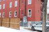 A police cruiser was parked near the property’s back lane, where several window’s on the ground floor appeared to have been shattered by non-lethal projectiles fired during the standoff. (Tyler Searle / Winnipeg Free Press)