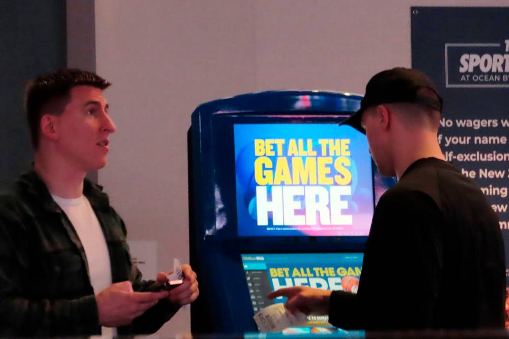 Wayne Parry / The Associated Press Files
People make bets at the sportsbook at the Ocean Casino Resort in Atlantic City, N.J., last year. Overall, it’s estimated more than $1.3 billion was bet on the NFL’s Super Bowl game last Sunday.