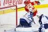 Winnipeg Jets goalie Connor Hellebuyck is scored on by Calgary Flames’ Oliver Kylington (58) during first period NHL hockey action in Calgary, Alta., Monday, Feb. 19, 2024. (Larry MacDougal / The Canadian Press)