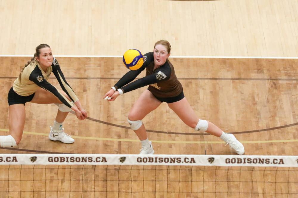 Dave Mahussier photo
Ella Gray (left) looks on as Julia Arnold bumps the ball.