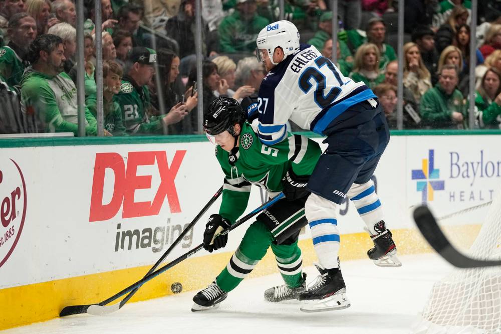 Dallas Stars defenceman Nils Lundkvist controls the puck while under pressure from Winnipeg Jets left wing Nikolaj Ehlers in the second period. (AP Photo/Tony Gutierrez)