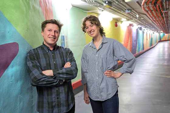 Toby Gillies and Natalie Baird show off Outside Light, a 300-foot mural the artists painted in the tunnel at St. Boniface Hospital, which connects to the McEwen Building, home to the hospital’s mental health program. (Ruth Bonneville / Free Press)
